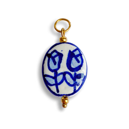 Pendentif en céramique et acier inoxydable doré ovale avec dessins de tulipes bleu et blanc. 